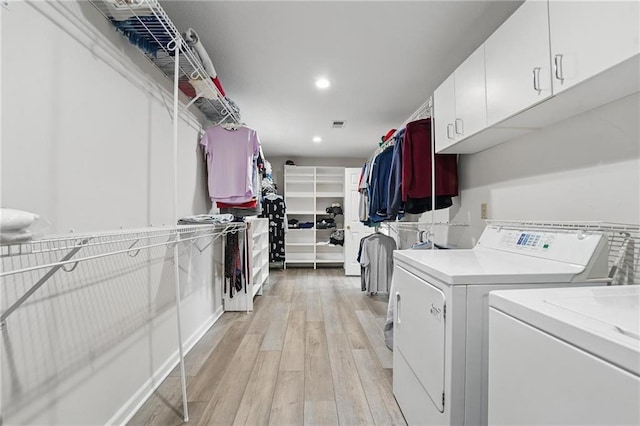14927 S Caenen Ln, Olathe, KS 66062 - laundry area with washing machine and dryer, cabinet space, light wood finished floors, and recessed lighting