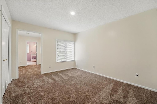 14927 S Caenen Ln, Olathe, KS 66062 - unfurnished bedroom featuring carpet flooring, a textured ceiling, a closet, baseboards, and recessed lighting