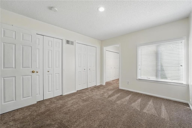 14927 S Caenen Ln, Olathe, KS 66062 - unfurnished bedroom featuring carpet, a textured ceiling, multiple closets, and baseboards