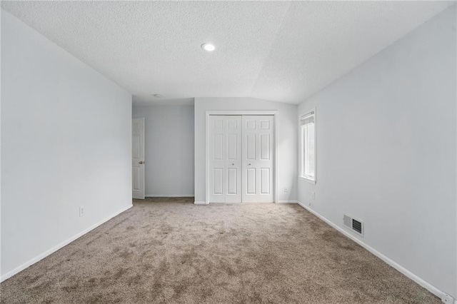 14927 S Caenen Ln, Olathe, KS 66062 - unfurnished bedroom with a textured ceiling, carpet, a closet, baseboards, and recessed lighting