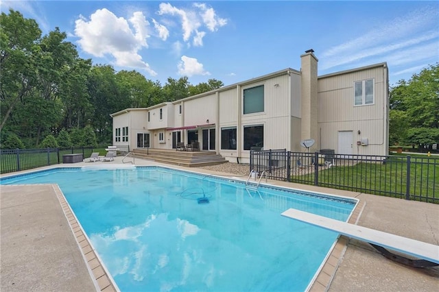14927 S Caenen Ln, Olathe, KS 66062 - view of pool featuring a patio, a diving board, and view of wooded area