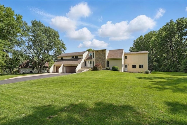 14927 S Caenen Ln, Olathe, KS 66062 - view of front of property with a garage, asphalt driveway, and a front lawn