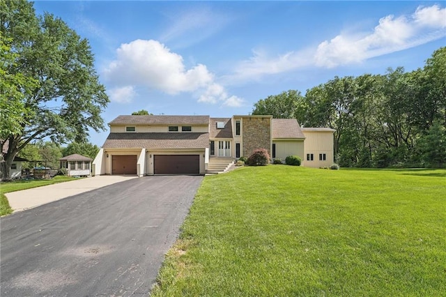 14927 S Caenen Ln, Olathe, KS 66062 - view of front facade with asphalt driveway, an attached garage, and a front yard