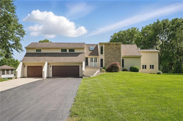 14927 S Caenen Ln, Olathe, KS 66062 - view of front of property with driveway, an attached garage, a front yard, and a shingled roof