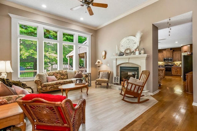 9008 N Hunter Ave, Kansas City, MO 64157 - living area with a ceiling fan, light wood-style floors, a tile fireplace, ornamental molding, and recessed lighting