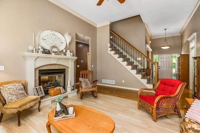 9008 N Hunter Ave, Kansas City, MO 64157 - living room with a ceiling fan, wood finished floors, stairs, baseboards, and crown molding