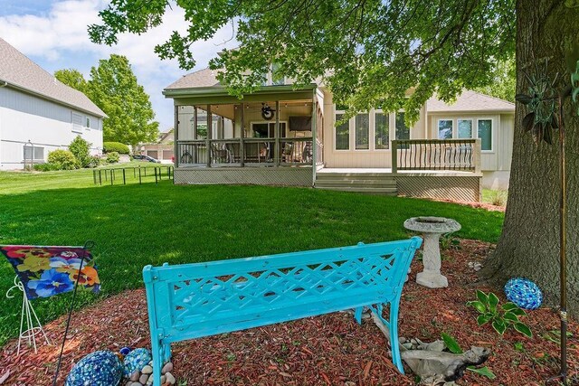 9008 N Hunter Ave, Kansas City, MO 64157 - rear view of house with a lawn and a wooden deck