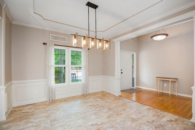 9008 N Hunter Ave, Kansas City, MO 64157 - empty room with crown molding, a chandelier, wainscoting, decorative columns, and a decorative wall