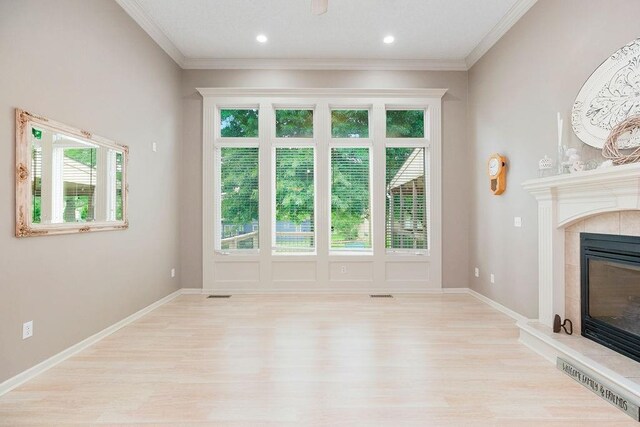 9008 N Hunter Ave, Kansas City, MO 64157 - unfurnished living room with a fireplace, light wood-type flooring, plenty of natural light, and ornamental molding