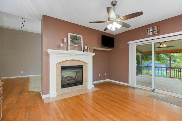 9008 N Hunter Ave, Kansas City, MO 64157 - unfurnished living room featuring wood finished floors, ceiling fan, and a fireplace