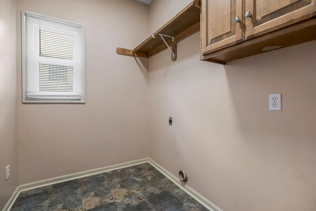 9008 N Hunter Ave, Kansas City, MO 64157 - washroom featuring electric dryer hookup, cabinet space, and stone finish floors