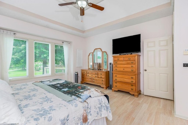 9008 N Hunter Ave, Kansas City, MO 64157 - bedroom with light wood-type flooring and a ceiling fan