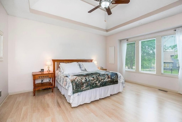 9008 N Hunter Ave, Kansas City, MO 64157 - bedroom with a raised ceiling, wood finished floors, and a ceiling fan