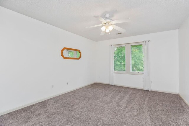 9008 N Hunter Ave, Kansas City, MO 64157 - spare room featuring carpet, a ceiling fan, and a textured ceiling