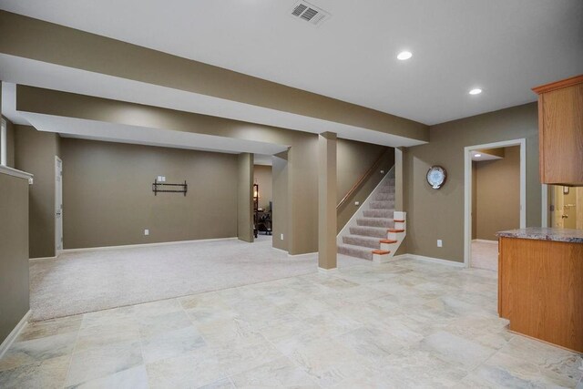 9008 N Hunter Ave, Kansas City, MO 64157 - finished below grade area featuring stairway, recessed lighting, and light carpet