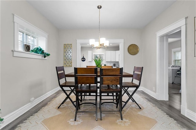915 E 29th St, Kansas City, MO 64109 - dining room with light wood-type flooring, a chandelier, baseboards, and plenty of natural light