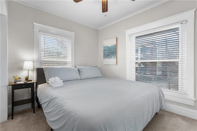 915 E 29th St, Kansas City, MO 64109 - carpeted bedroom featuring multiple windows, crown molding, and ceiling fan