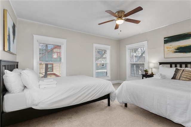 915 E 29th St, Kansas City, MO 64109 - bedroom with light carpet, baseboards, crown molding, and ceiling fan