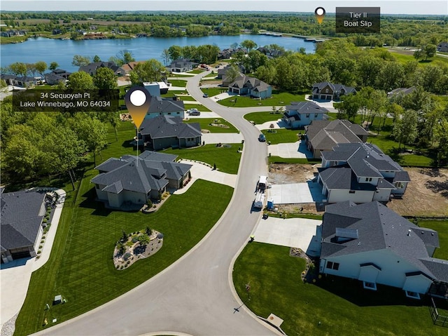 aerial view of residential area featuring a large body of water