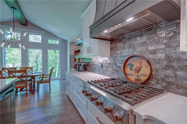 kitchen featuring custom range hood, stainless steel appliances, white cabinetry, and backsplash