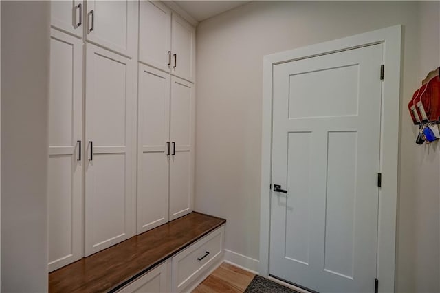 mudroom featuring light wood-style floors and baseboards