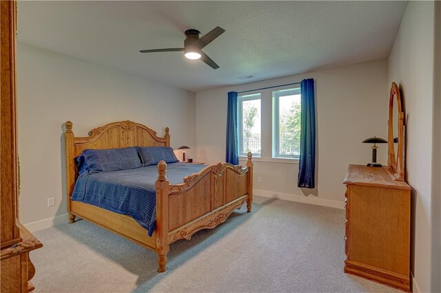 bedroom featuring carpet, baseboards, and a ceiling fan