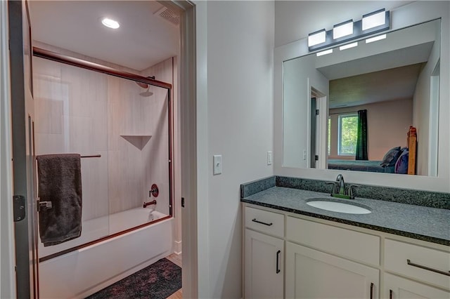 bathroom with vanity and bath / shower combo with glass door