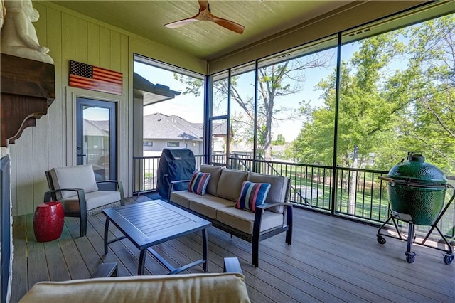 sunroom with an outdoor living space and a ceiling fan