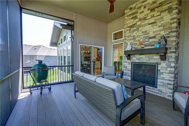 wooden terrace featuring an outdoor stone fireplace