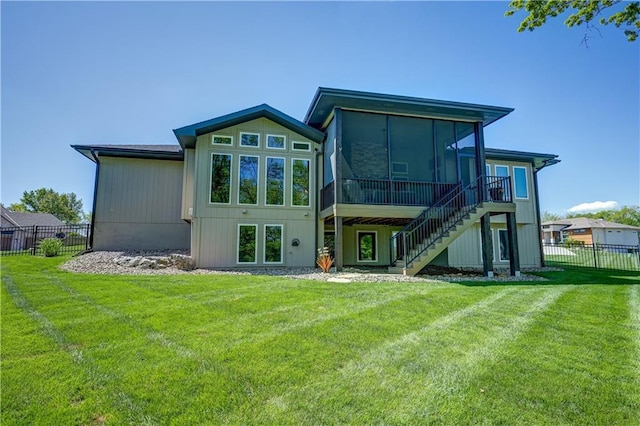 rear view of property featuring a sunroom and stairway