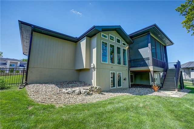 back of house featuring a sunroom and stairs