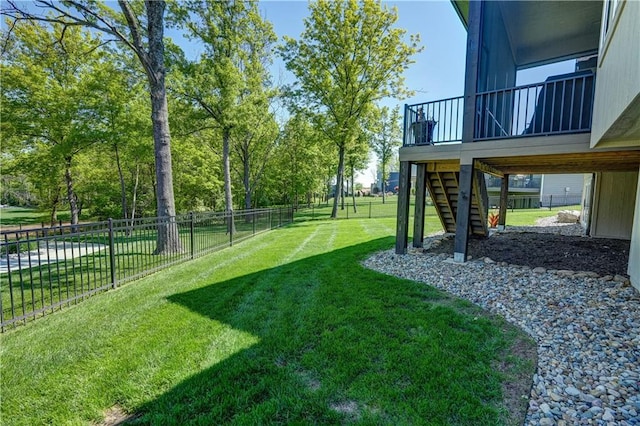 view of yard with stairs and a deck