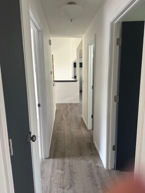 7037 N Holmes St, Gladstone, MO 64118 - hallway featuring wood finished floors and baseboards