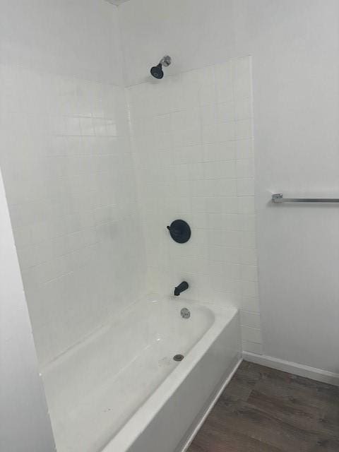 7037 N Holmes St, Gladstone, MO 64118 - bathroom with wood finished floors, baseboards, and shower / tub combination
