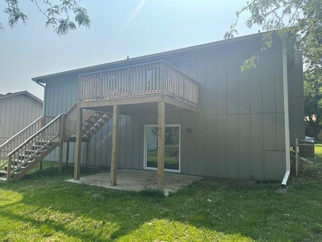7037 N Holmes St, Gladstone, MO 64118 - rear view of property with a patio area, a lawn, and stairway