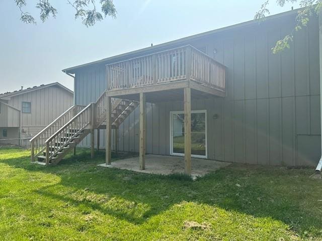 7037 N Holmes St, Gladstone, MO 64118 - rear view of house featuring a patio, a lawn, stairs, and a deck