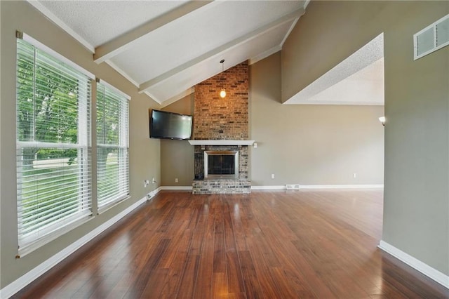 unfurnished living room featuring hardwood / wood-style floors, a fireplace, and baseboards