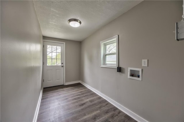 entryway featuring baseboards, healthy amount of natural light, a textured ceiling, and dark wood finished floors