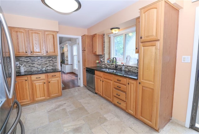 2218 Condolea Ter, Leawood, KS 66209 - kitchen with a sink, stainless steel appliances, tasteful backsplash, dark stone counters, and baseboards