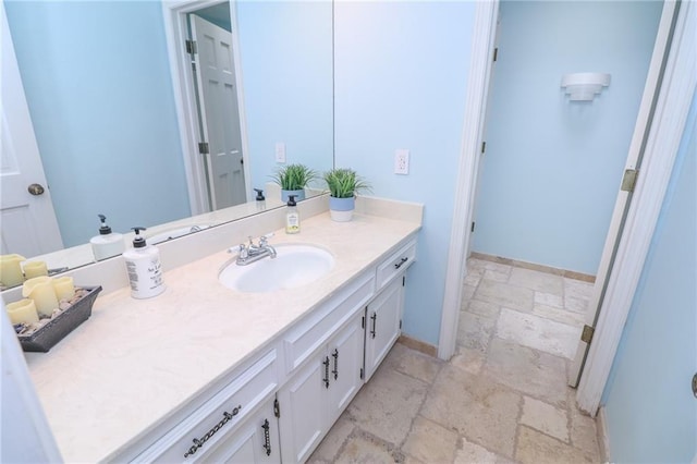 2218 Condolea Ter, Leawood, KS 66209 - bathroom featuring stone tile floors, vanity, and baseboards