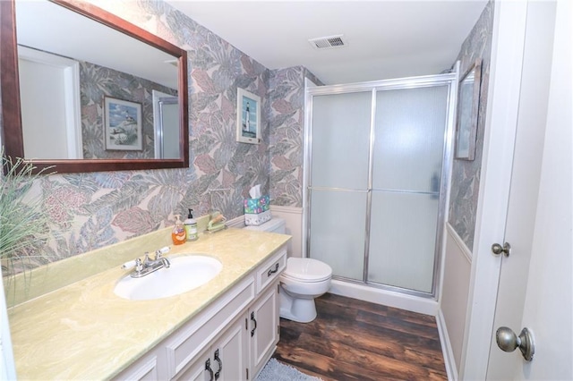 2218 Condolea Ter, Leawood, KS 66209 - bathroom featuring wallpapered walls, wood finished floors, a stall shower, vanity, and toilet