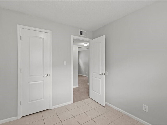 310-312 N 8th St, Leavenworth, KS 66048 - unfurnished bedroom featuring baseboards and light tile patterned floors