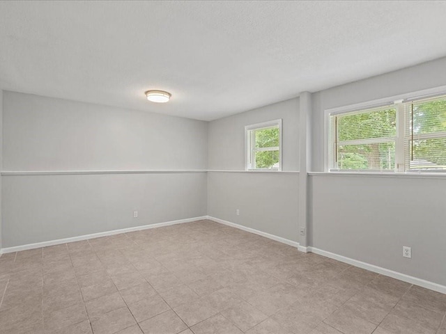 310-312 N 8th St, Leavenworth, KS 66048 - spare room featuring baseboards and a textured ceiling