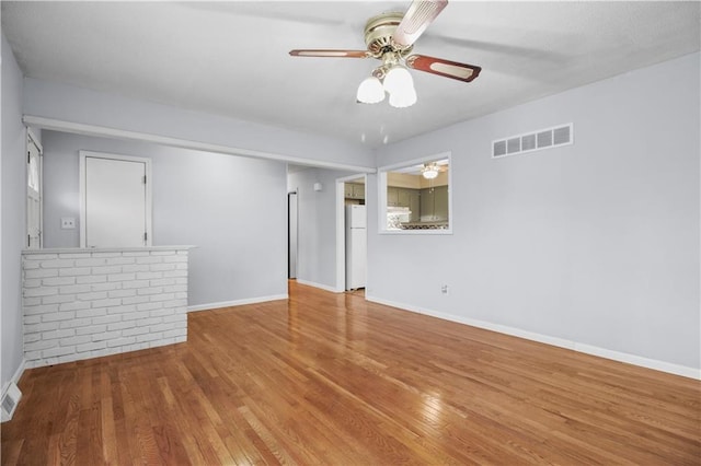 1608 SE Hillside Dr, Oak Grove, MO 64075 - unfurnished room with wood finished floors, ceiling fan, and baseboards