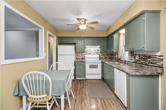 1608 SE Hillside Dr, Oak Grove, MO 64075 - kitchen with white appliances, a sink, under cabinet range hood, ceiling fan, and wood finished floors
