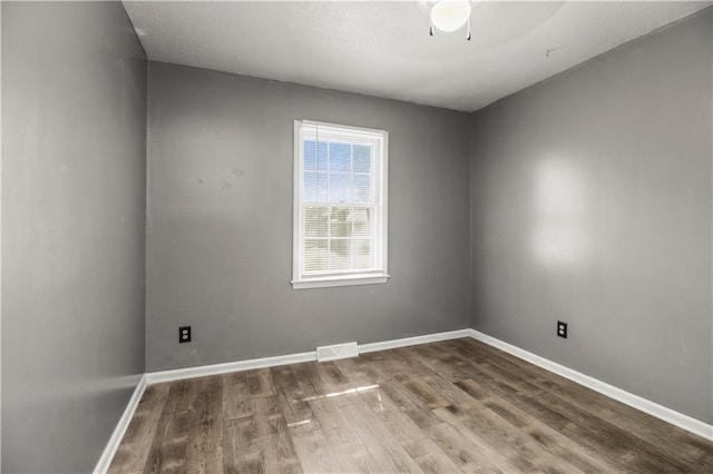 1608 SE Hillside Dr, Oak Grove, MO 64075 - empty room featuring wood finished floors, baseboards, and a ceiling fan