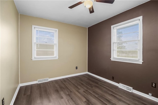 1608 SE Hillside Dr, Oak Grove, MO 64075 - spare room featuring dark wood finished floors, a ceiling fan, and healthy amount of natural light
