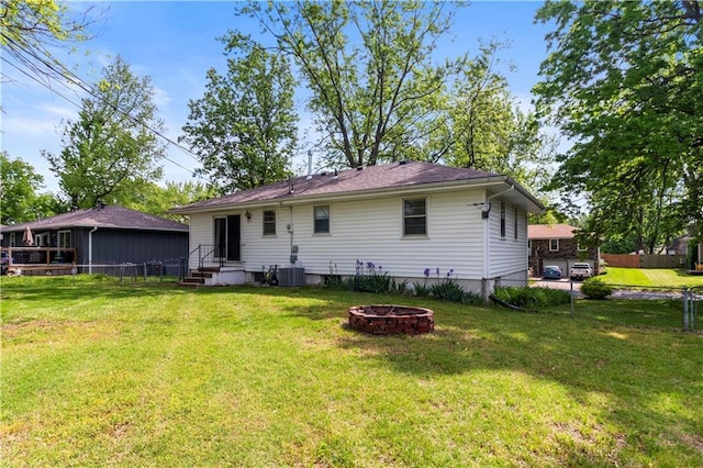 1608 SE Hillside Dr, Oak Grove, MO 64075 - back of property with a fire pit and central air condition unit