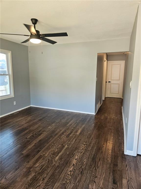 4715 E 45th St, Kansas City, MO 64130 - empty room featuring baseboards, dark wood-style floors, and ceiling fan