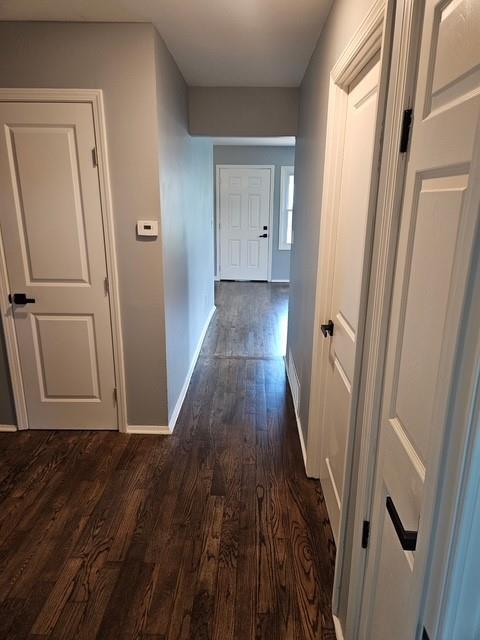 4715 E 45th St, Kansas City, MO 64130 - hall featuring dark wood-style flooring and baseboards